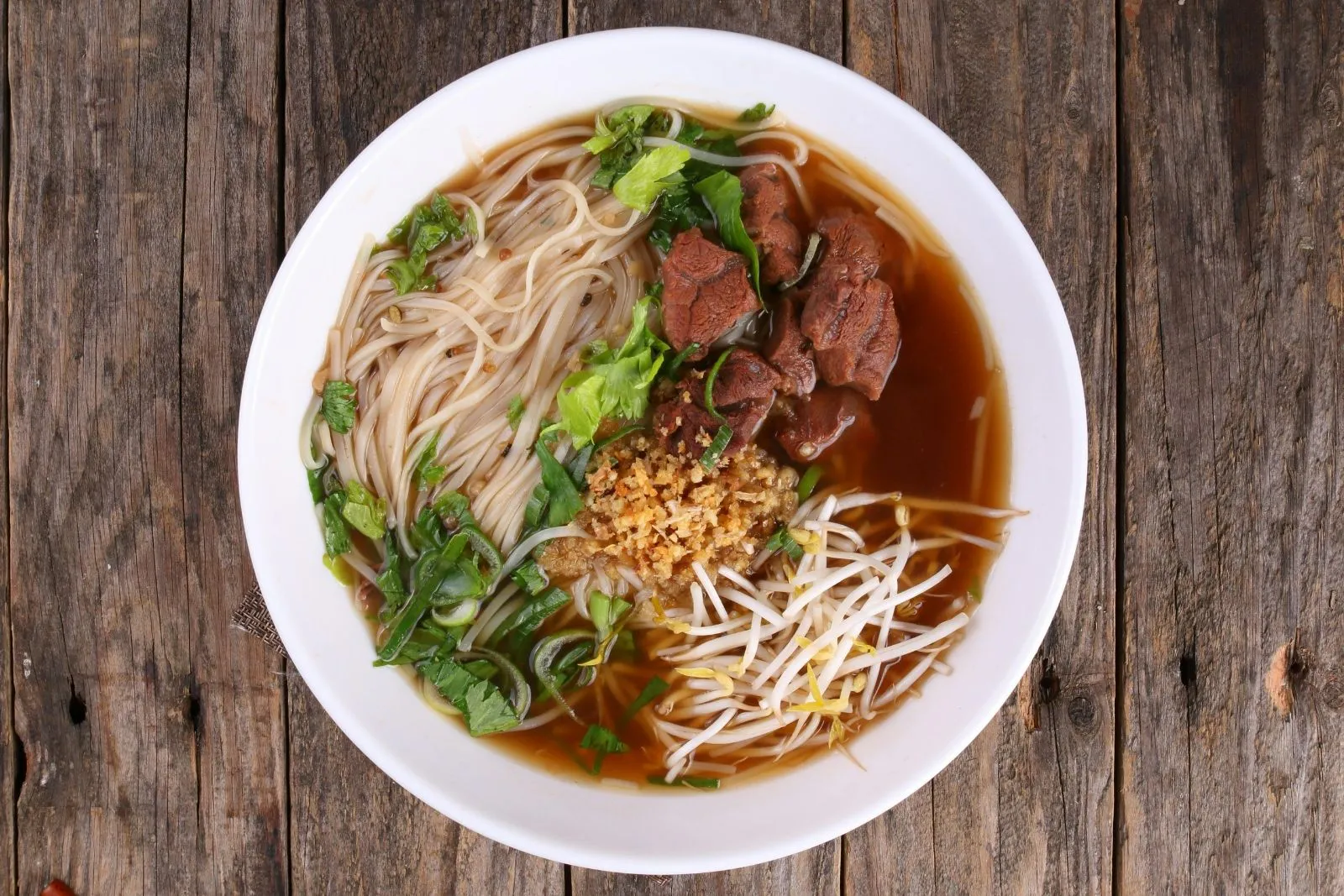 Beef pho noodle soup with herbs and sprouts at Phorainbow, a Vietnamese Restaurant in Brooklyn